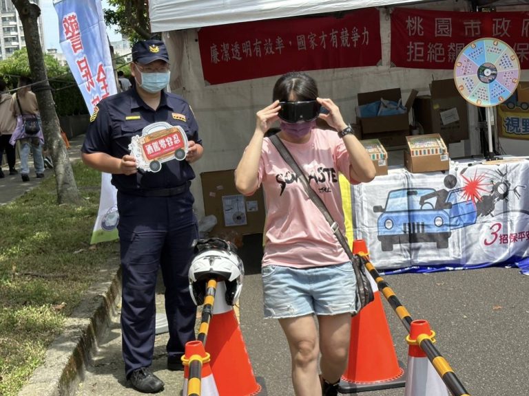 龜山分局讓民眾戴上「醉酒模擬眼鏡」體驗酒醉情境，宣導酒後駕車的危險性。(記者張欽翻攝)