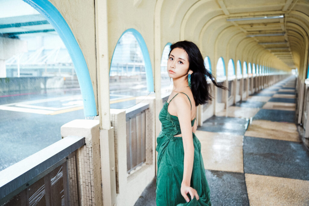 前「天氣女孩劉玳妍身穿綠色的蝴蝶綠色洋裝,代表「破繭重生」,特別在上映前重回《女孩》的電影場景拍攝,也像過去宣告,象徵華麗轉身。(圖/阿卡莎納官方 提供)