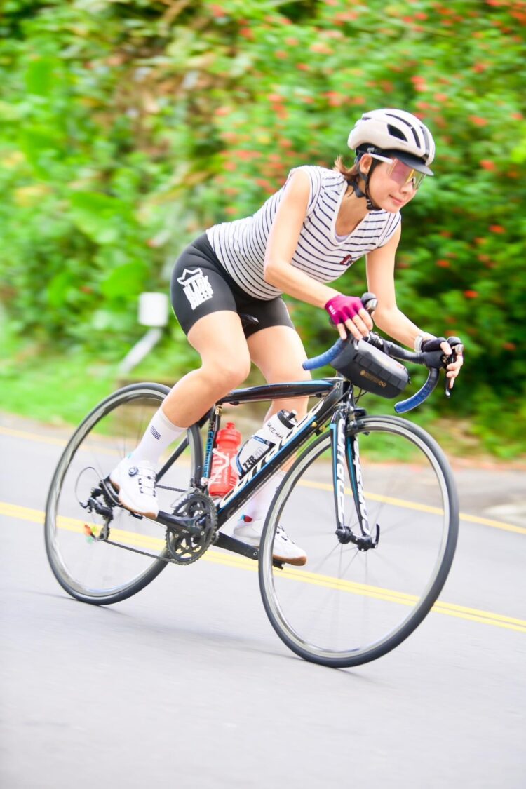 丁寧全力踩踏攻上高雄中寮山「魔王坡」,挑戰人生首場百K自行車耐力賽,展現堅毅神情與從容氣度。(圖/記者張家燁翻攝)